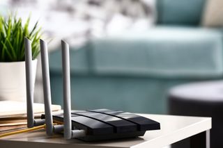 Wi-Fi router plugged in on a side table at home