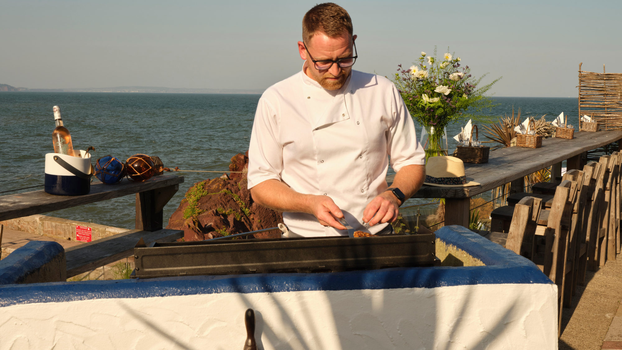 A chef at the outdoor barbecue at the Cary Arms & Spa.