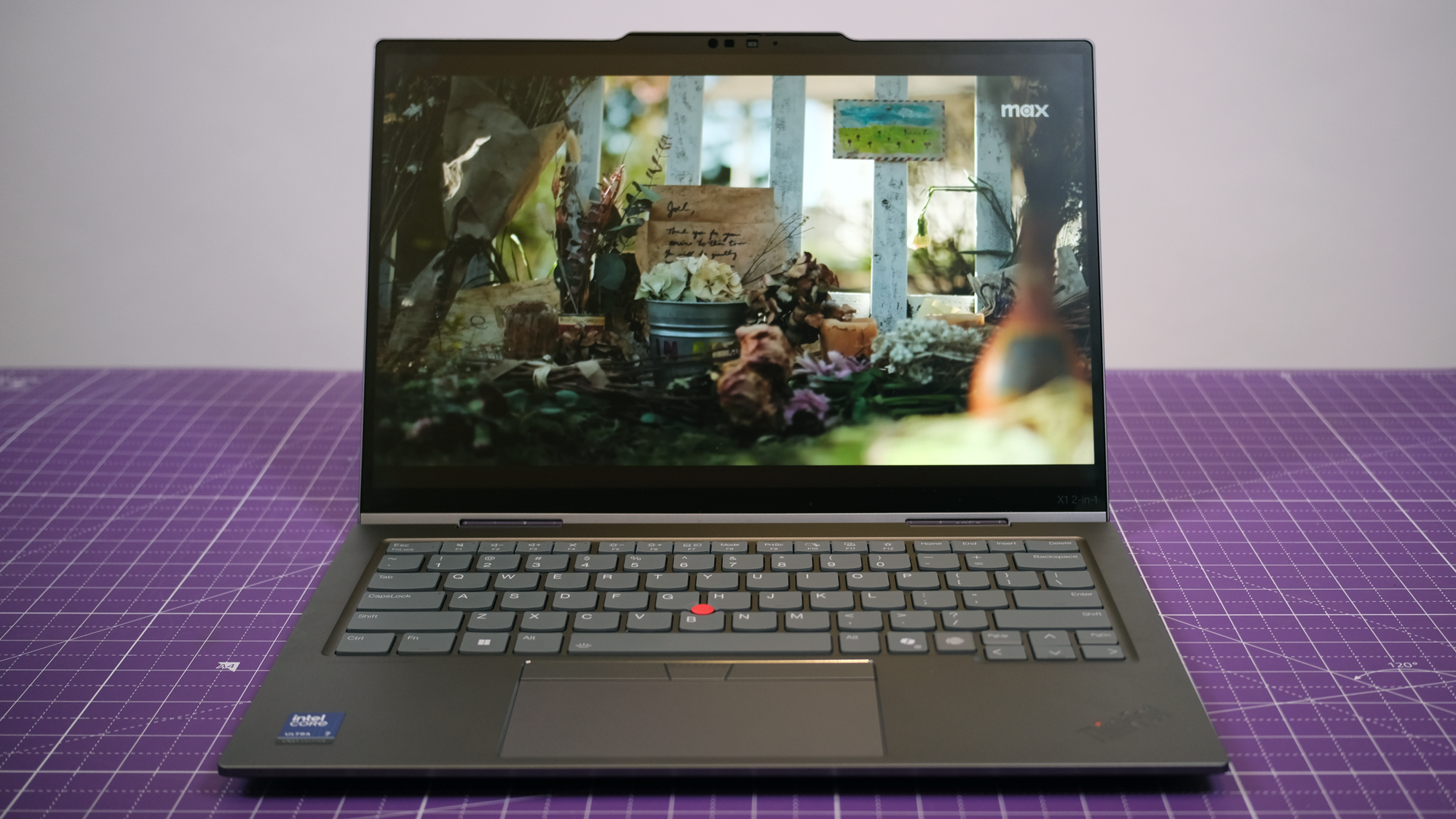 The ThinkPad X1 2-in-1 Gen 10 Aura Edition sitting on a purple table.