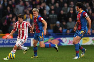 Stoke City's English striker Michael Owen (L) runs with the ball between Crystal Palace's Australian midfielder Mile Jedinak (R) and Norwegian midfielder Jonathan Parr (C) during the English FA Cup third round football match between Crystal Palace and Stoke City at Selhurst Park Stadium, South London on January 5, 2013.