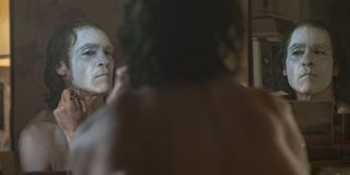 Joaquin Phoenix paints his face in Joker