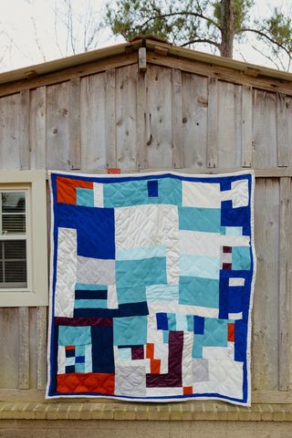 A patchwork quilt hanging on the wall