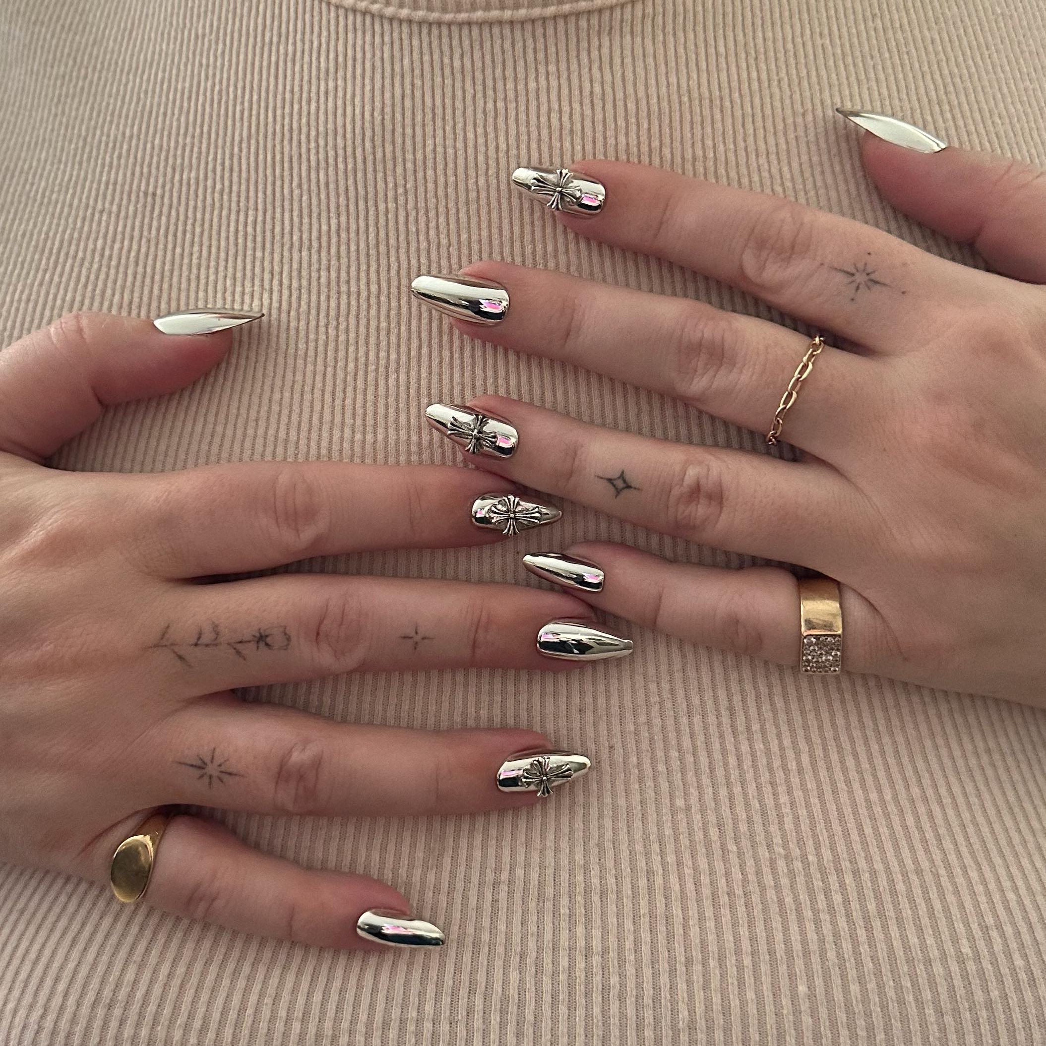 A silver chrome manicure with cross details by Brittney Boyce for Megan Fox