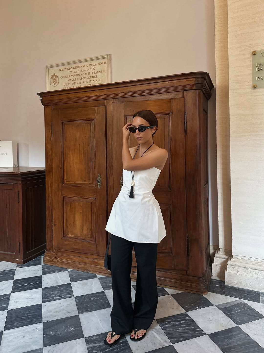 woman wearing strapless flared top and black pants summer 2025