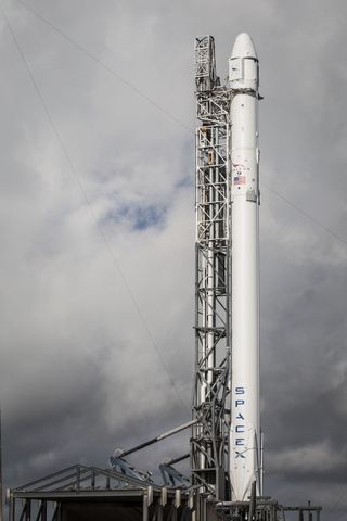 The SpaceX Falcon 9 rocket carrying a Dragon cargo ship for the Commercial Resupply Service 6 mission (CRS-6) is raised into vertical launch position atop a pad at the Cape Canaveral Air Force Station in Florida ahead of a planned liftoff on April 13, 201