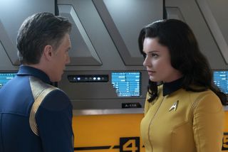 Capt. Pike (Anson Mount) consults with Number One (Rebecca Romijn), reporting from the starship Enterprise.