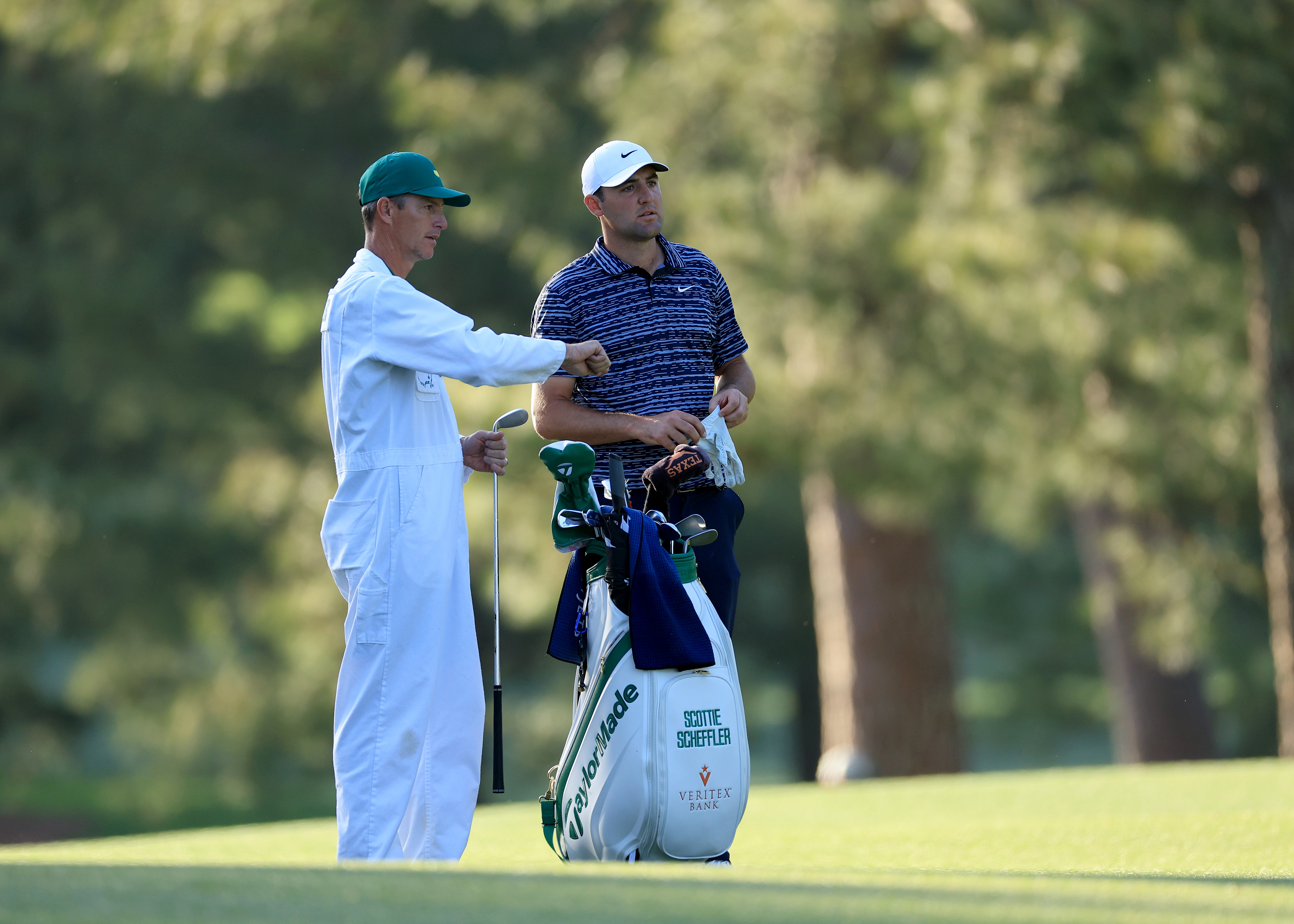 AUGUSTA, GEORGIA - APRIL 10: Scottie Scheffler chooses his club for his second shot on the par 4, 17th hole during teh final round of the 2002 Masters Tournament at Augusta National Golf Club on April 10, 2022 in Augusta, Georgia. (Photo by David Cannon/Getty Images)