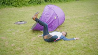 An Apprentice candidate falling over while trying to put up a tent.