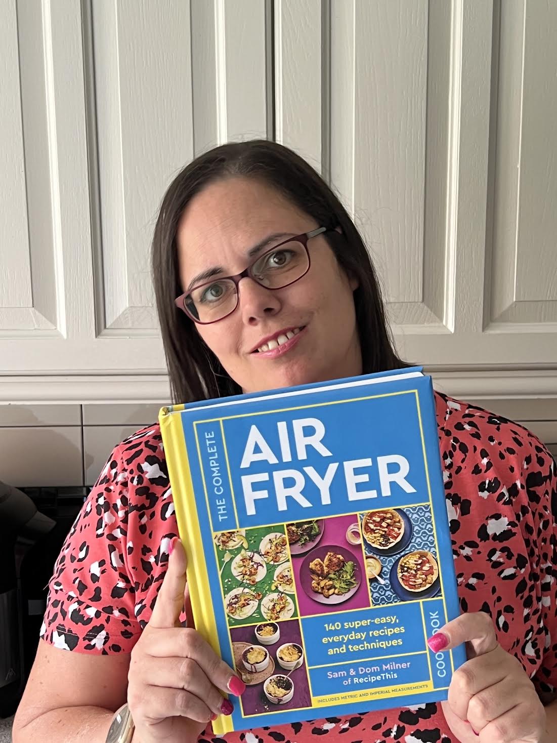 Picture of SAM MILNER with her book The Complete Air Fryer Cookbook 