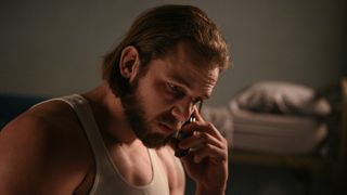 Max Thieriot as Bode Leone on the phone in Fire Country season 2