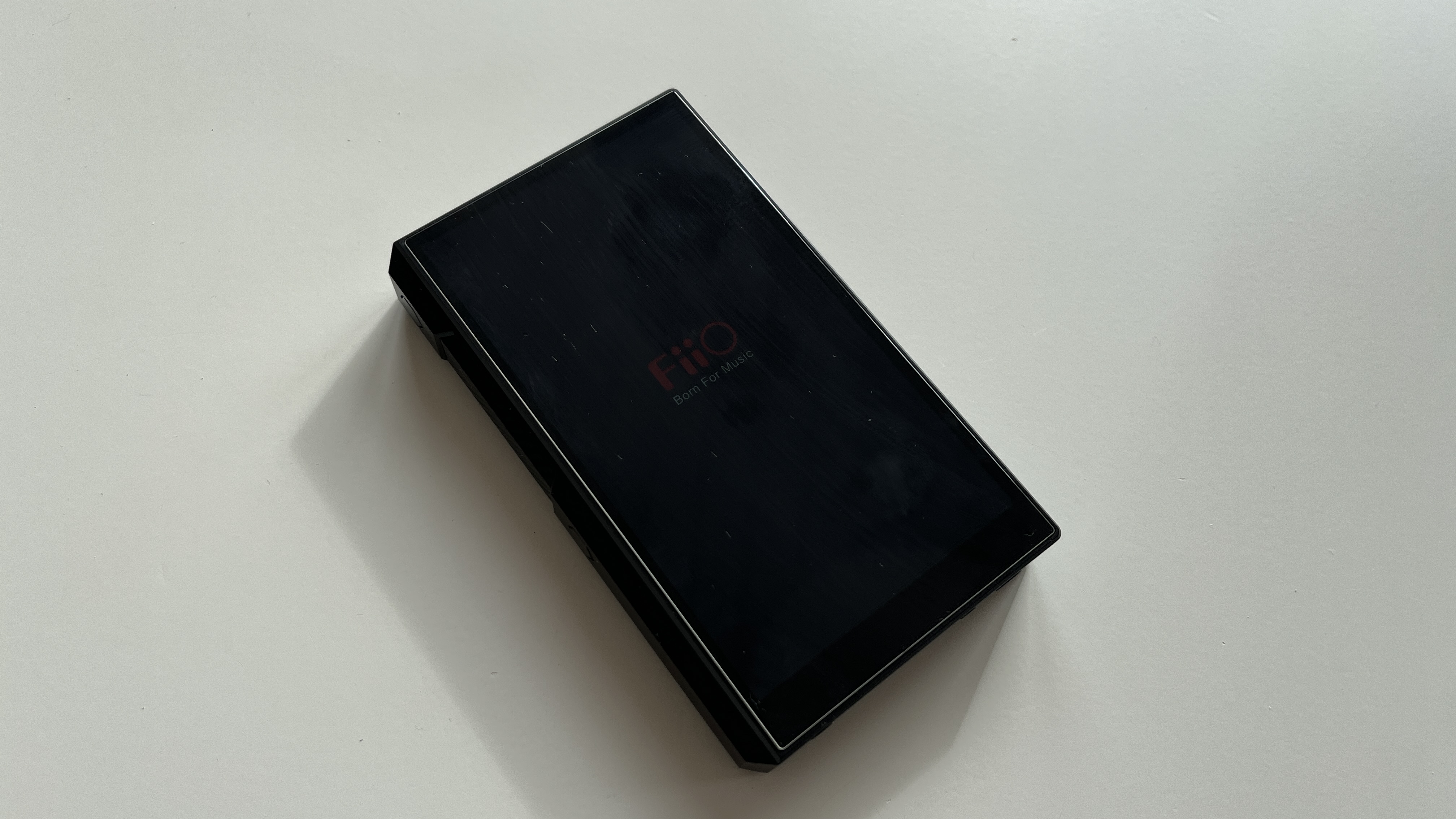 The FiiO M11S music player pictured with the screen off on a plain white surface