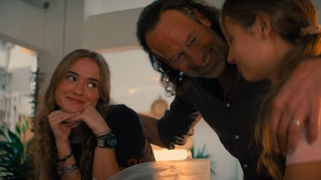 Johnny Sequoyah smiling at Troy Kotsur, who's smiling at Gia Hunter in Primate