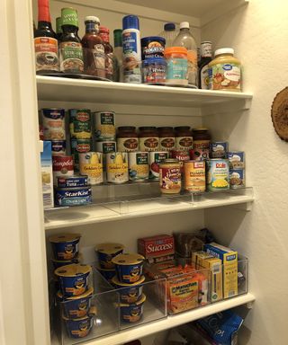 Organised pantry with cans on plastic risers