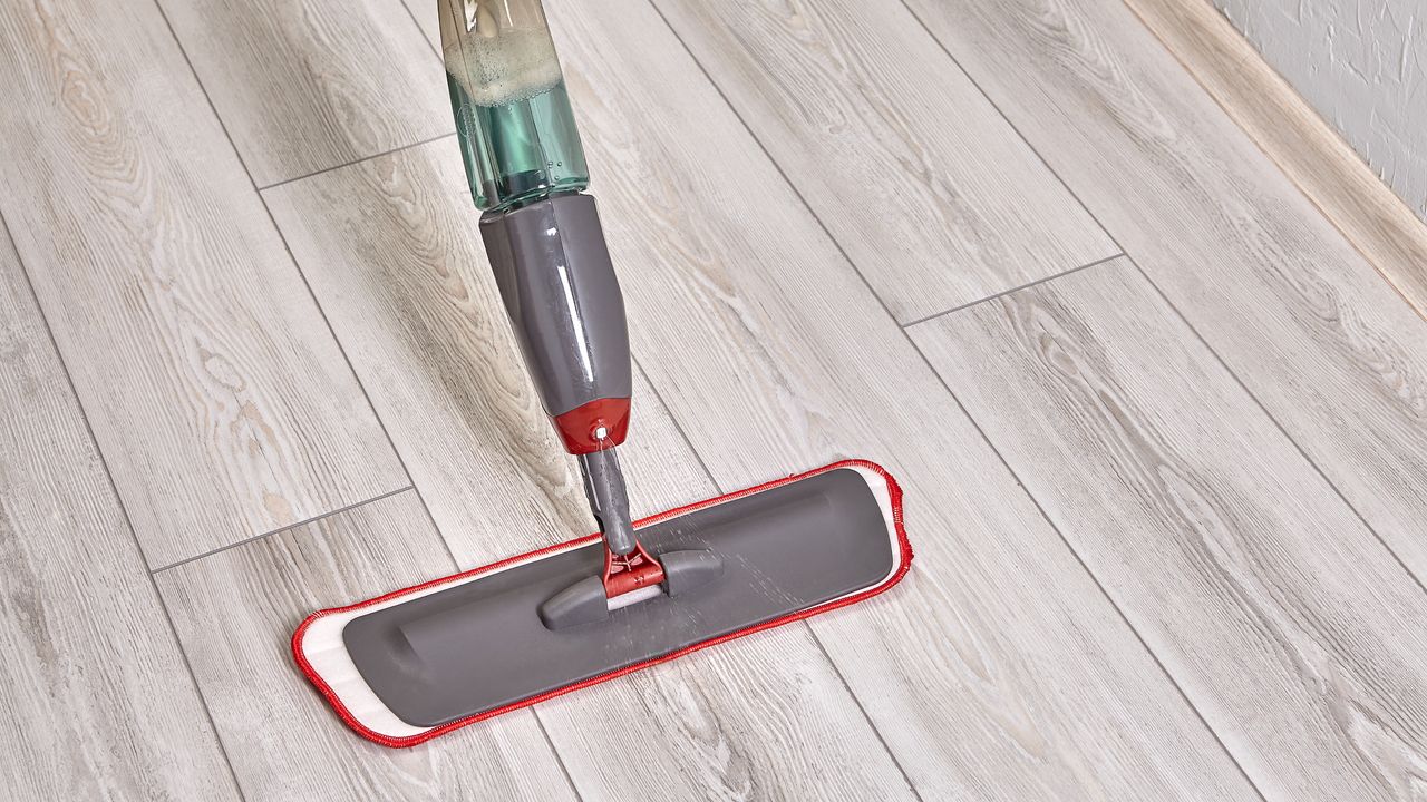 Grey spray mop on hard flooring