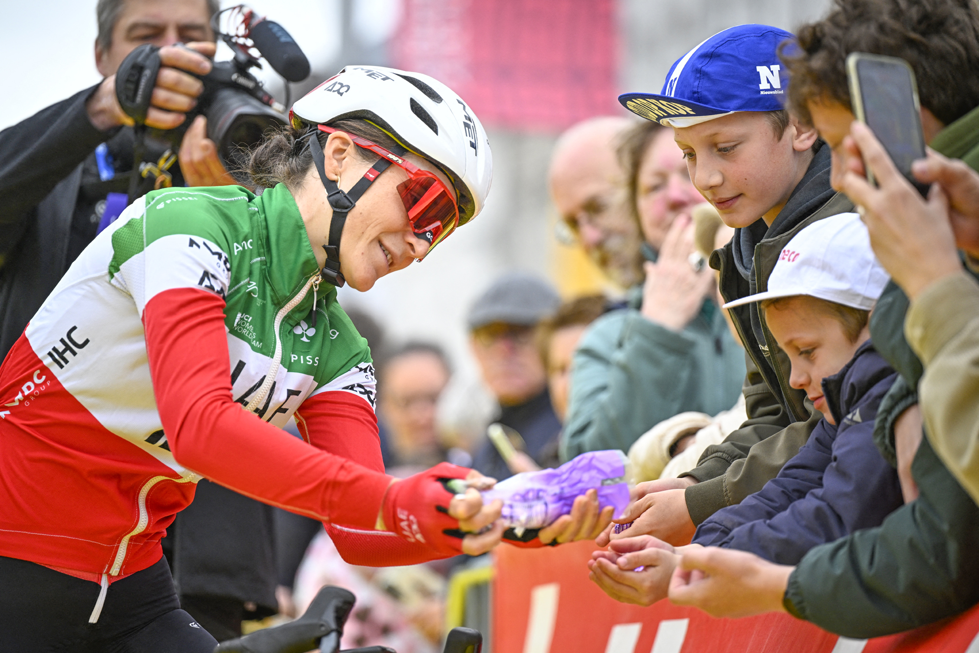 Italian champion Elisa Longo Borghini (UAE Team ADQ) signs items for young fans before the start of the 2026 Tour of Flanders
