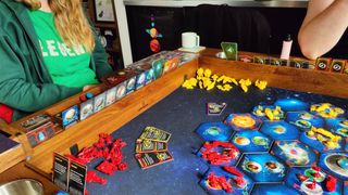 A side-on view of the Twilight Imperium board and cards in use