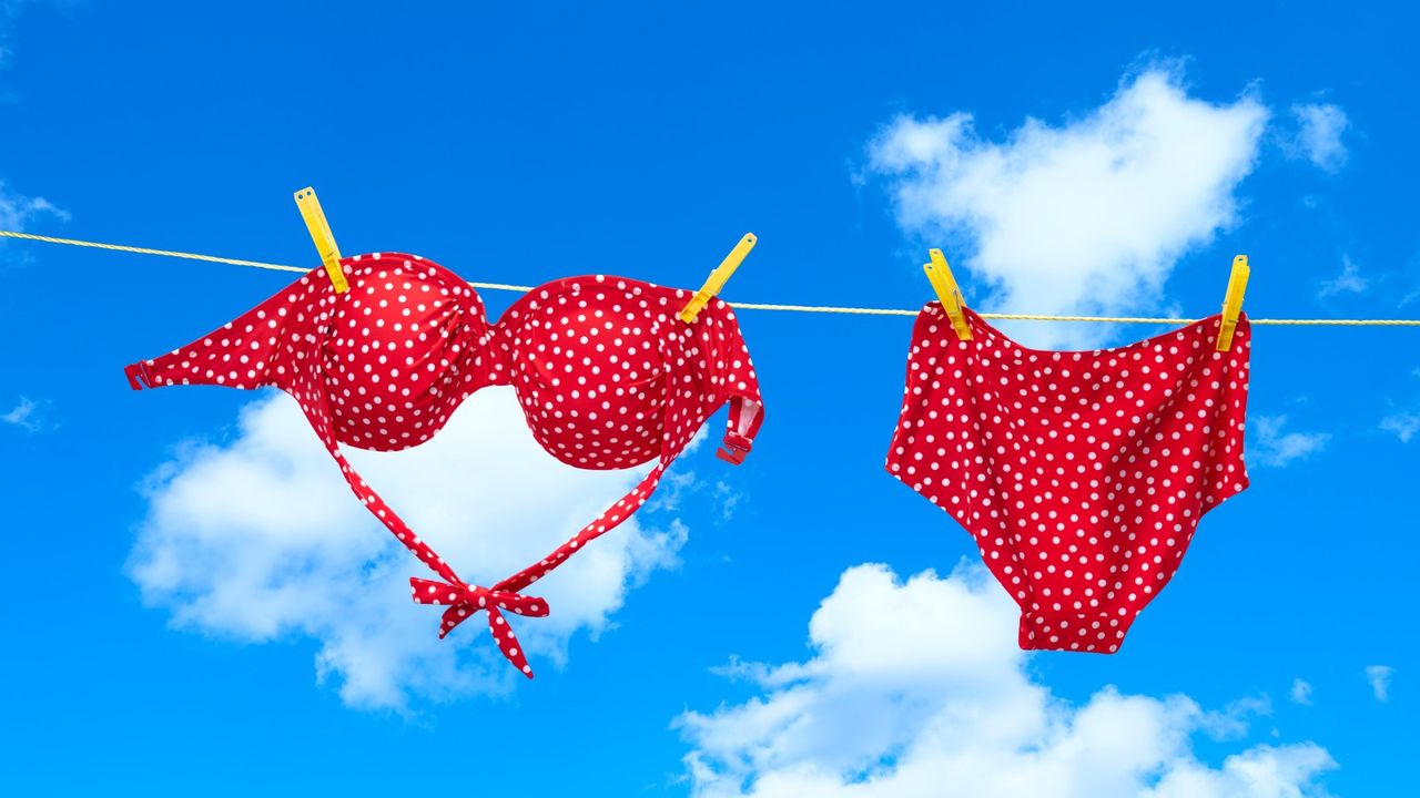 Wearing bikini top upside down, Red spotty bikini hanging on clothes line