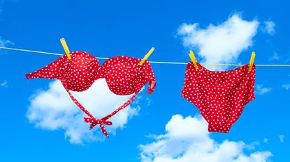 Wearing bikini top upside down, Red spotty bikini hanging on clothes line