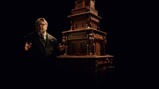 Guillermo del Toro stood next to the Cabinet of Curiosities