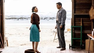 Maggie and Ron standing in the boat shed on the beach