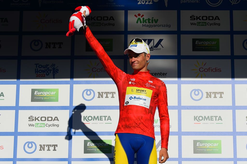 NYIREGYHAZA HUNGARY MAY 13 Aaron Van Poucke of Belgium and Team Sport Vlaanderen Baloise celebrates winning the red mountain jersey on the podium ceremony after the 43rd Tour de Hongrie 2022 Stage 3 a 154km stage from Sarospatak to Nyiregyhaza tourdehongrie on May 13 2022 in Nyiregyhaza Hungary Photo by Dario BelingheriGetty Images