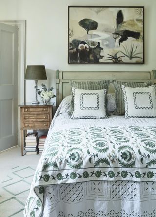 Green bed and lampshade, wooden bedside table