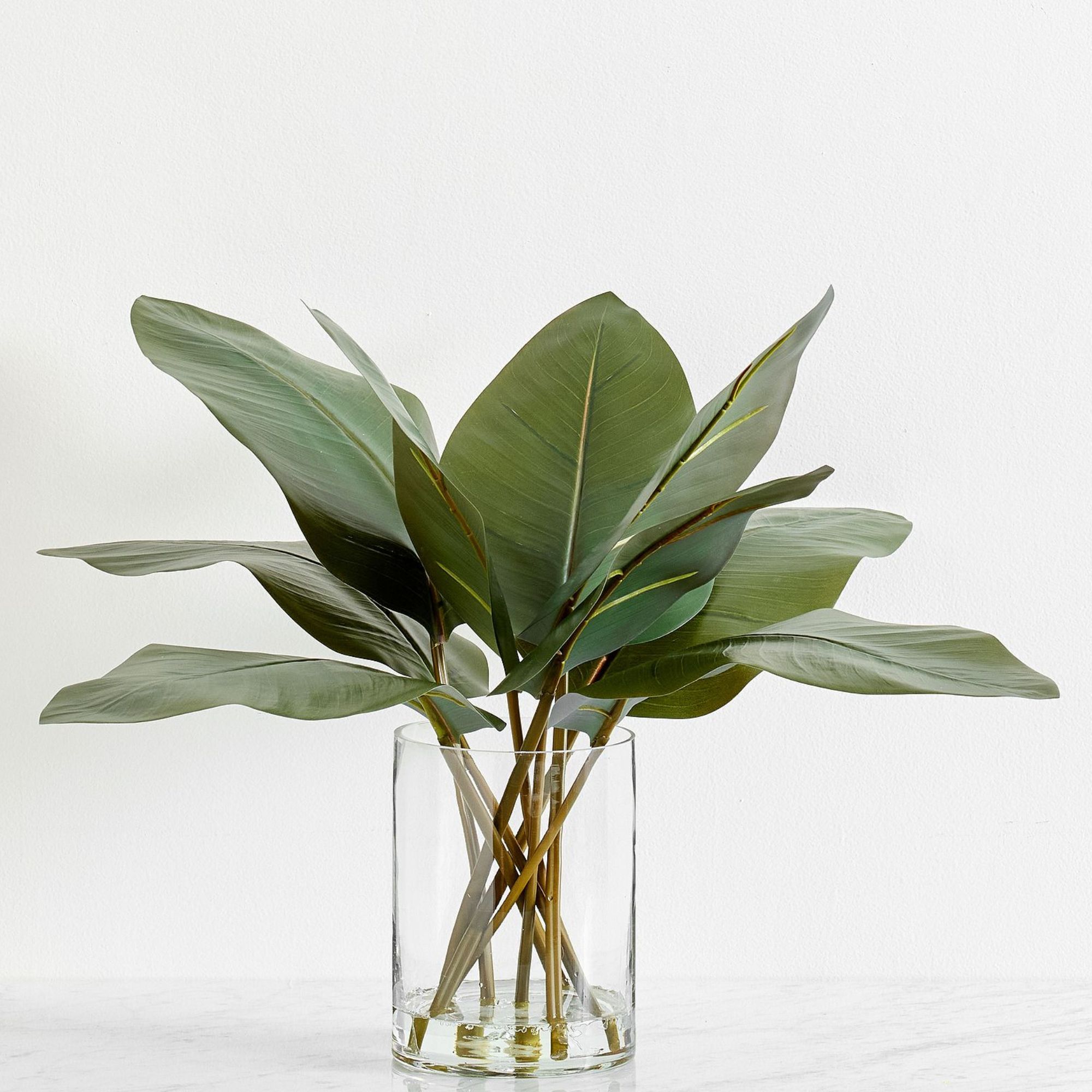 Pottery Barn Banana Leaf arrangement in a glass vase