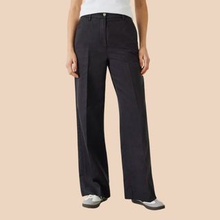 flat lay image of woman in black trousers 