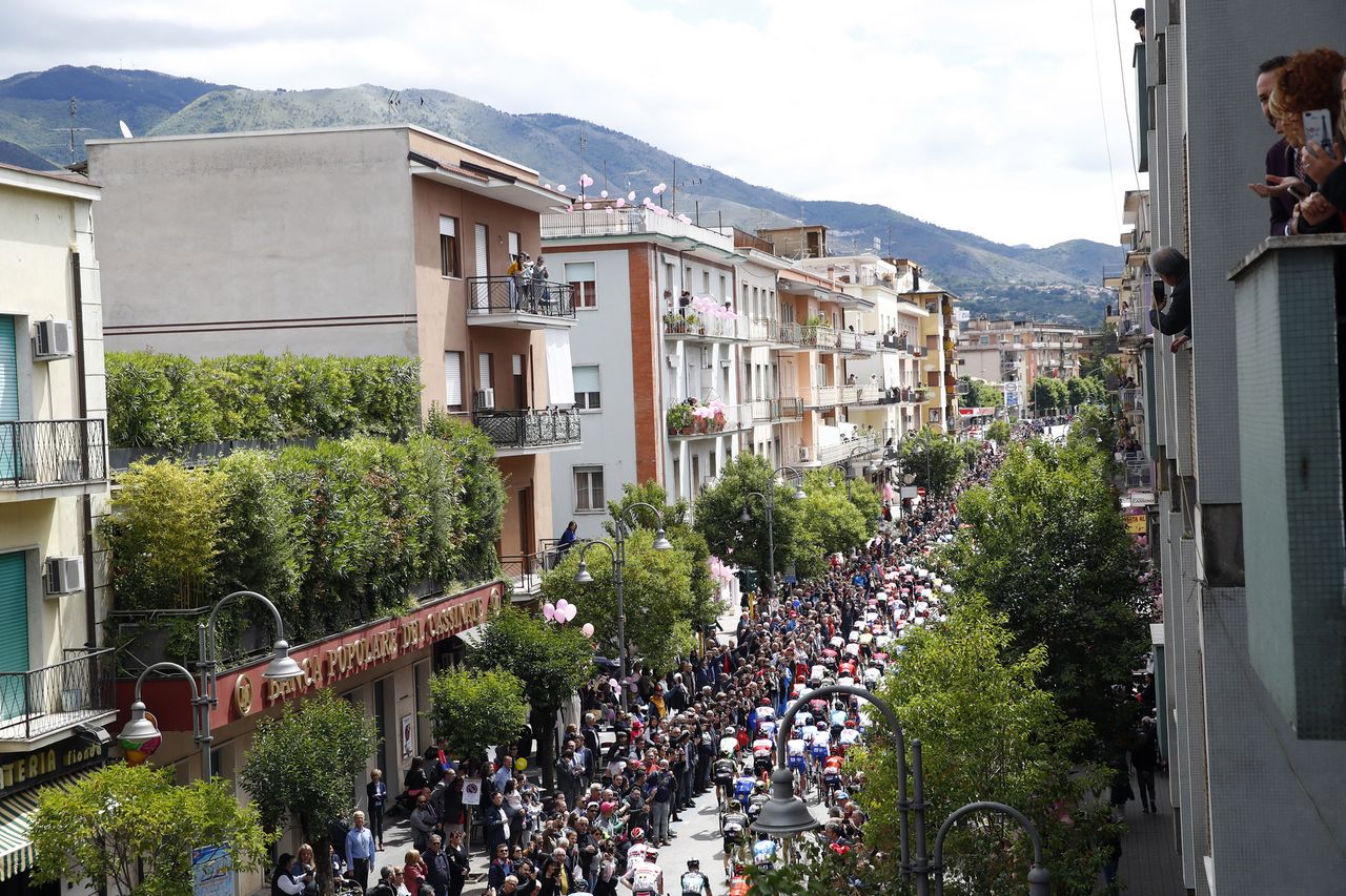 The peloton pass through a town