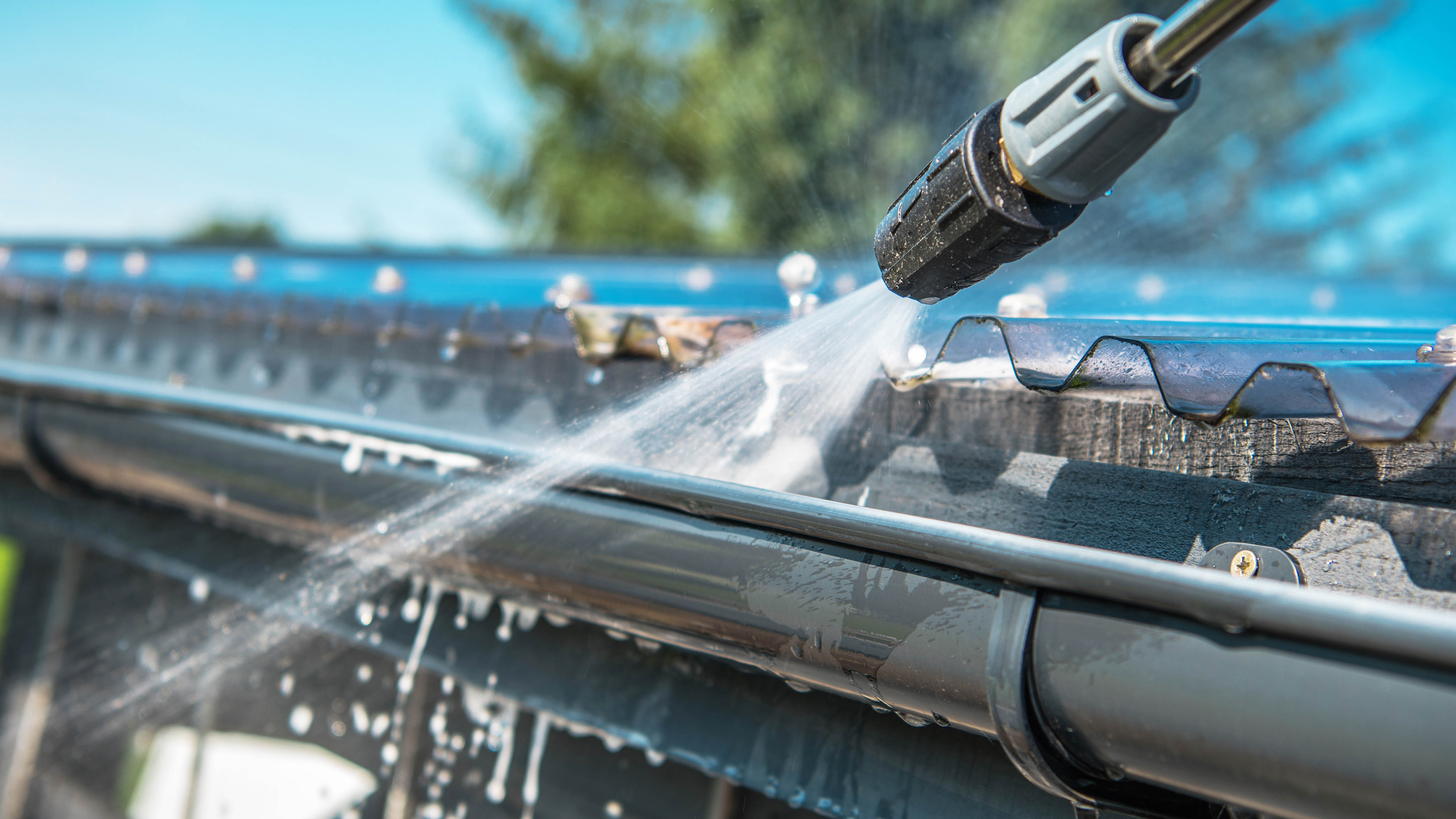 A high-pressure cleaner flushes the gutters