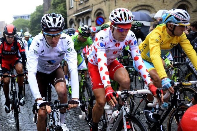 France's Romain Bardet wearing the best young's white jersey, France's Cyril Lemoine wearing the best climber's polka dot jersey, and Italy's Vincenzo Nibali wearing the overall leader's yellow jersey take the start