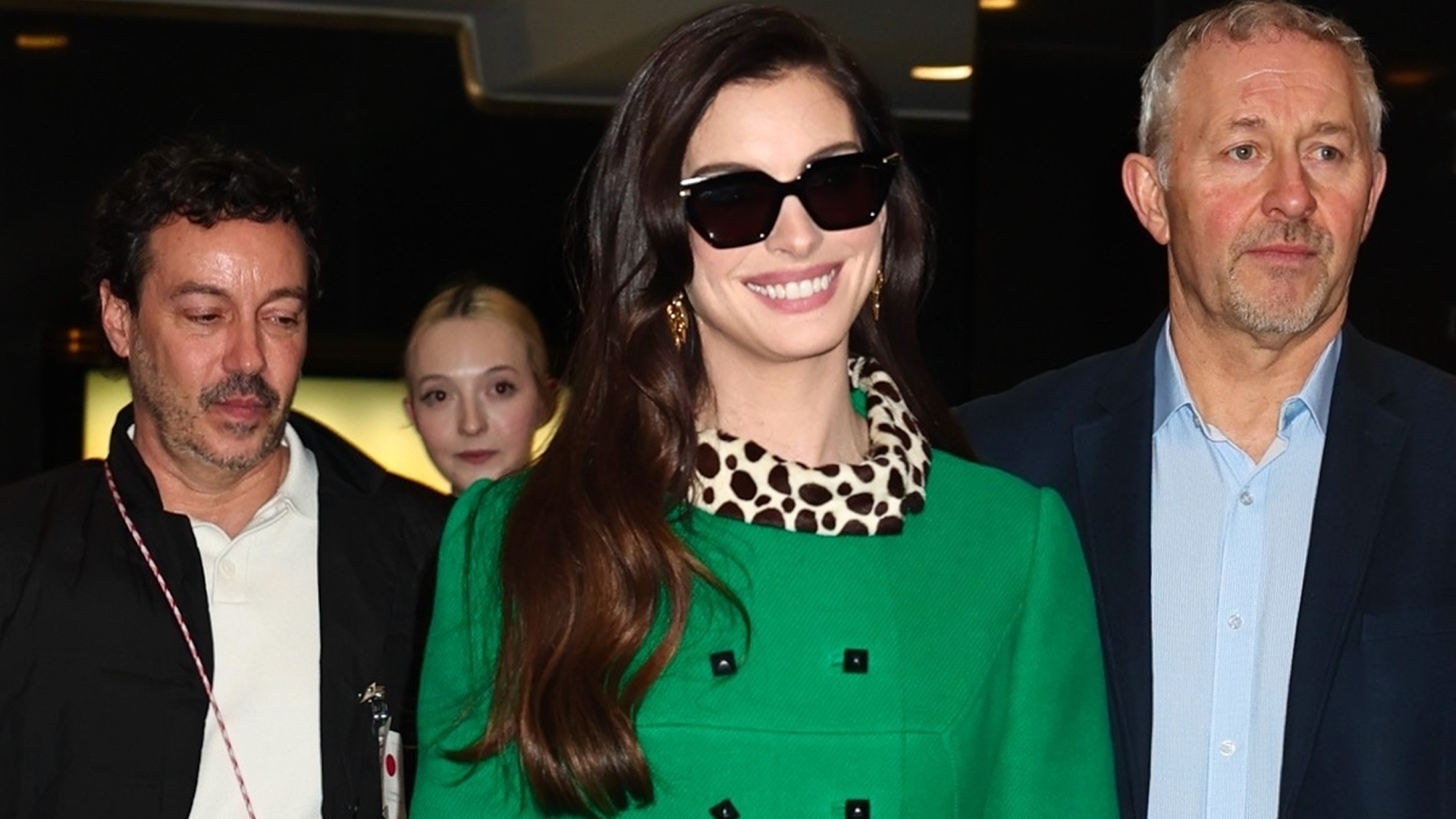 Anne Hathaway wore the green coat with leopard-print trim from the Devil Wears Prada on the Devil Wears Prada 2 press tour