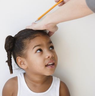 Child getting measured. 