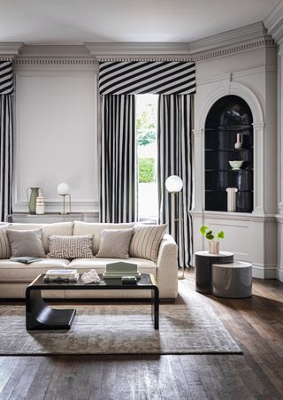 A black and white living room with a curtain in stripes