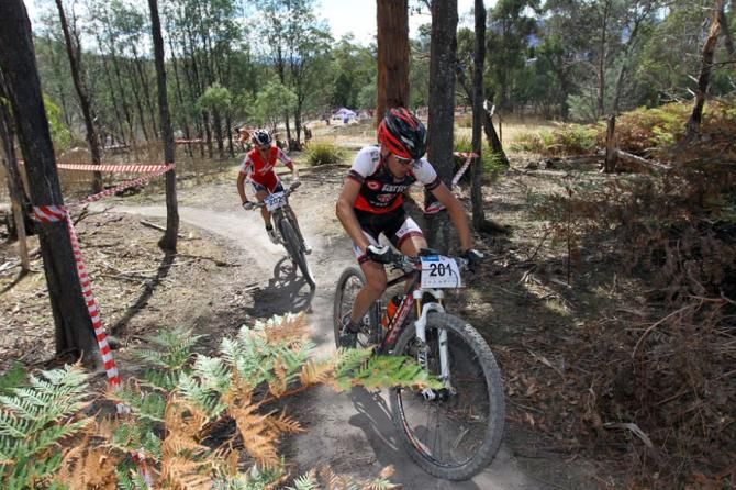 Chris Hamilton leads fellower U19 rider Ben Oliver into the switchback before the final climb