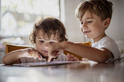 kids playing on iPad