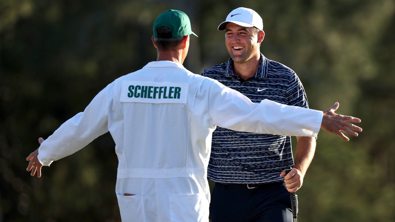 Ted Scott and Scottie Scheffler embrace after winning the 2022 Masters