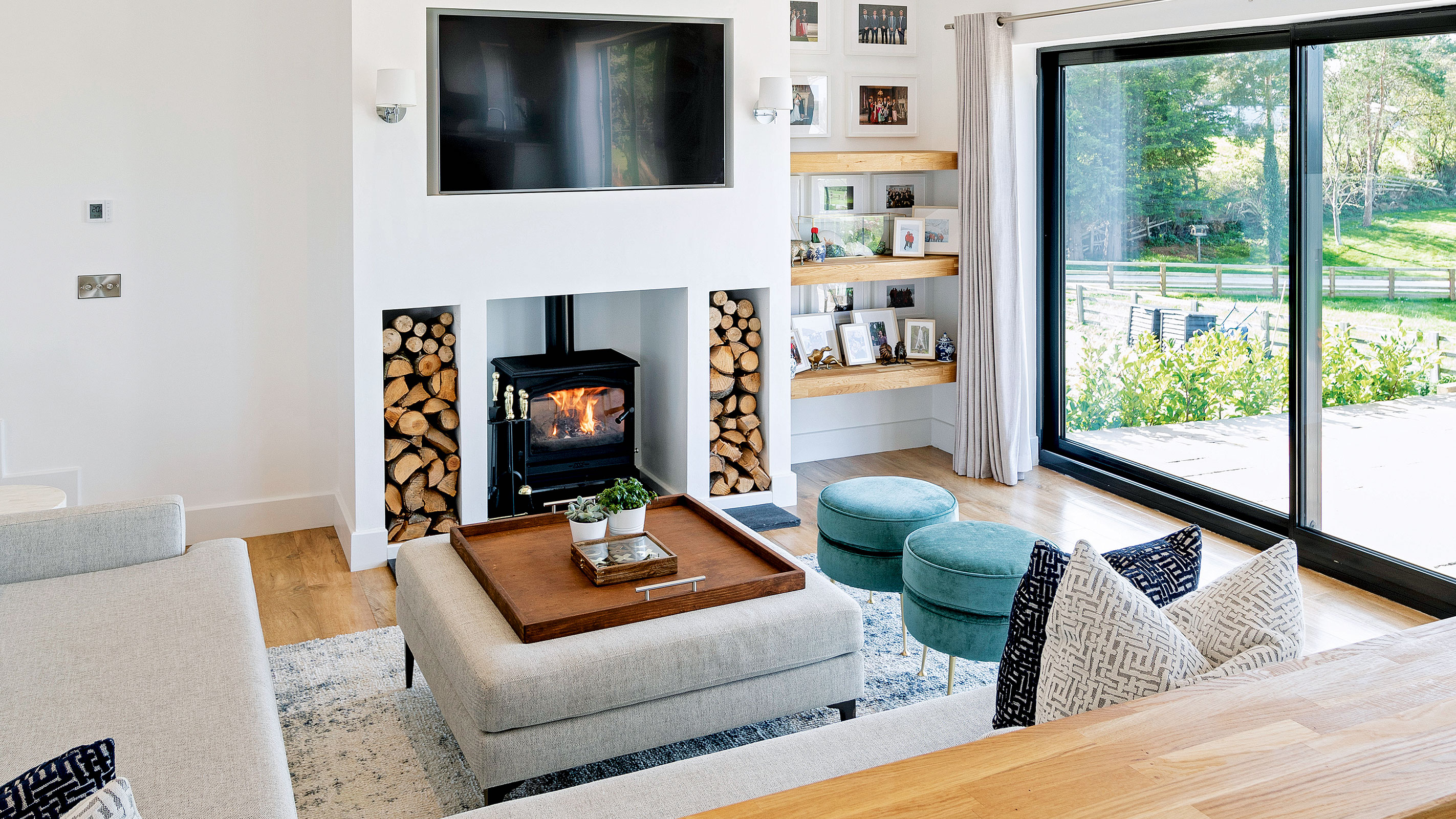 modern fireplace with log burning stove and log storage