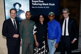 a group of met gala co chairs in front of an exhibit announcement