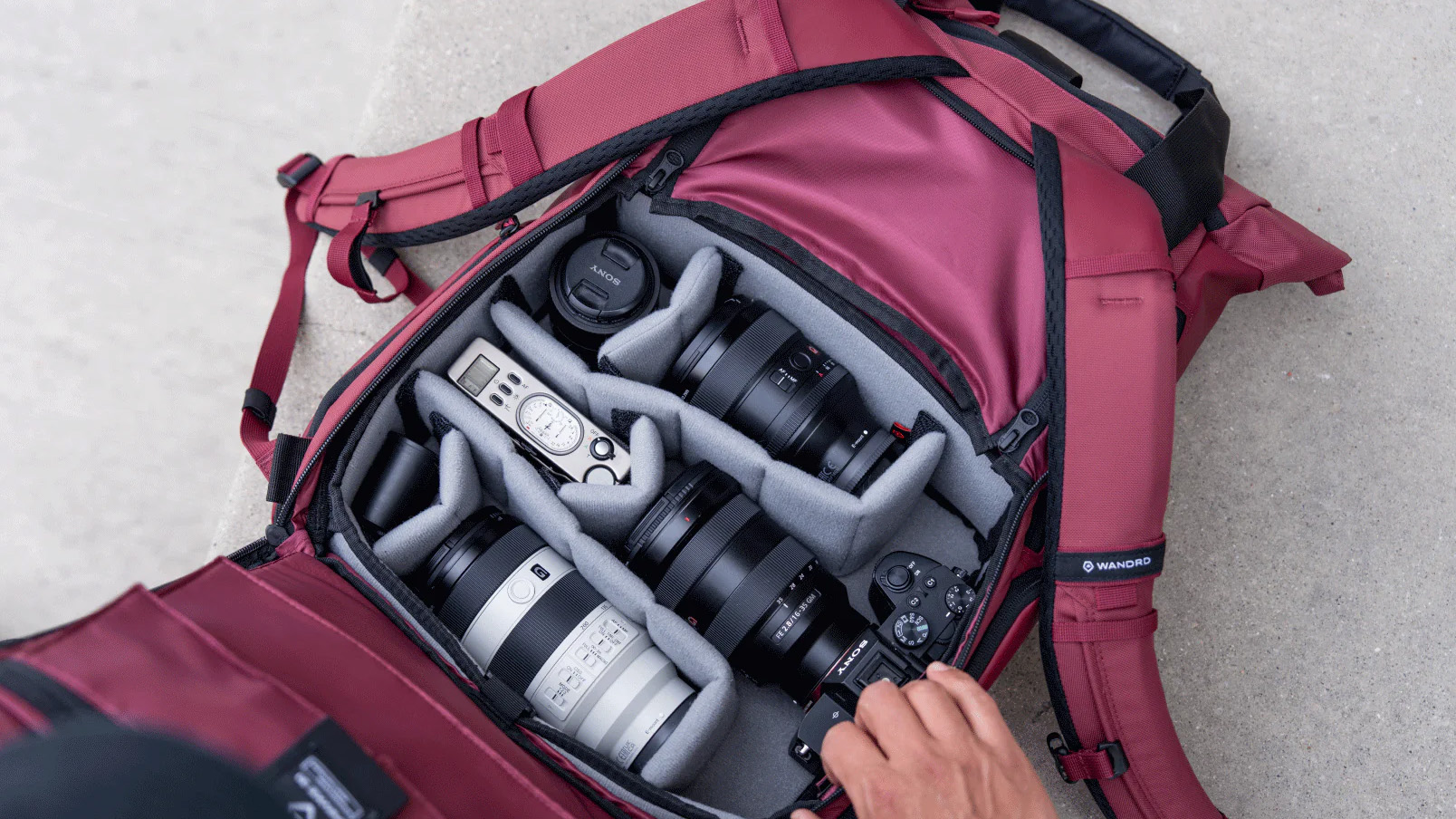 The Wandrd Prvke V4 opens from the back panel to access gear stored in a camera cube
