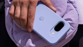 Pixel 9a in case held in hand