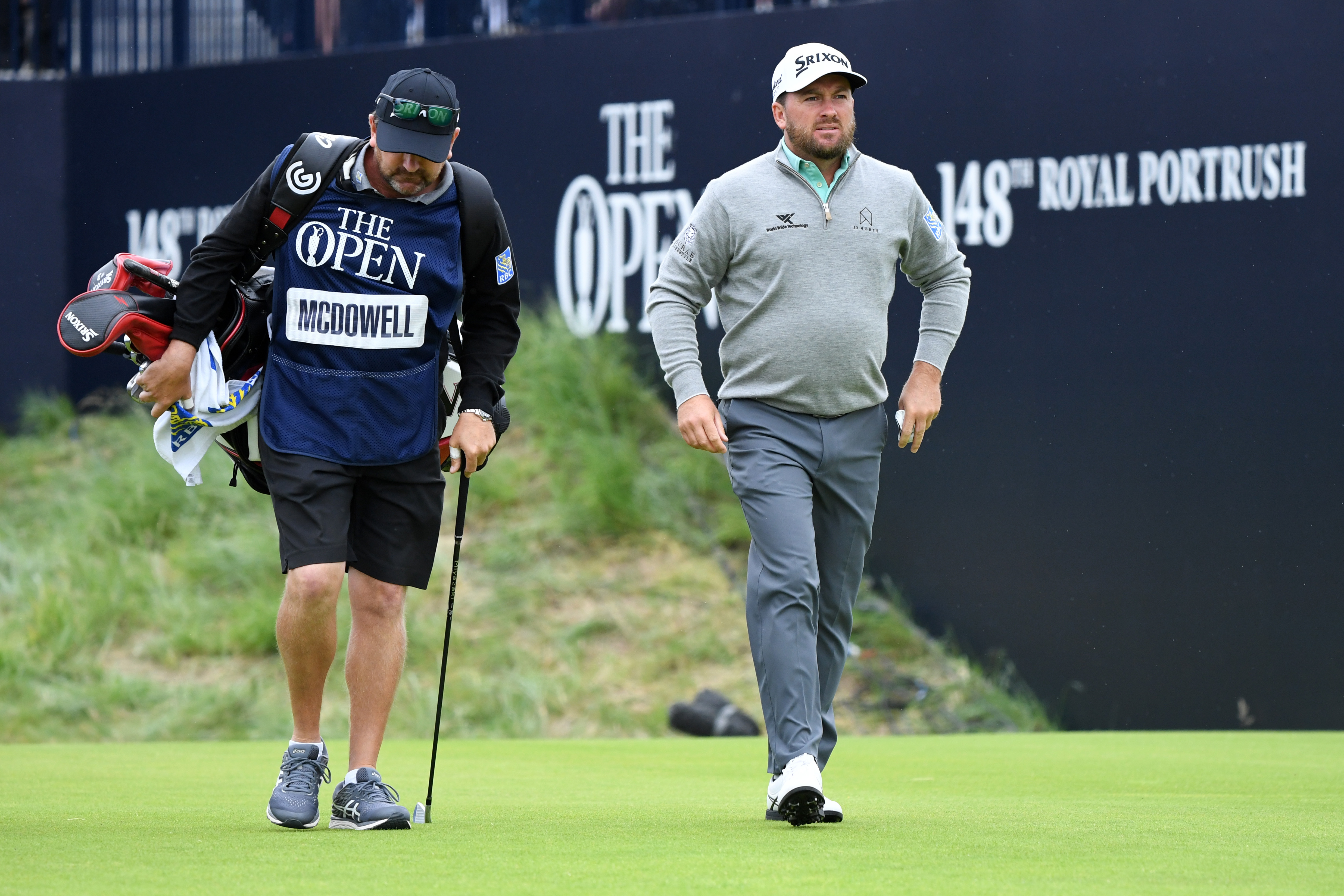 Graeme McDowell walks alongside his caddie at The Open in 2019