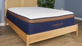 A closeup of the Brooklyn Bedding CopperFlex Pro Hybrid Mattress on a bed frame in a bedroom