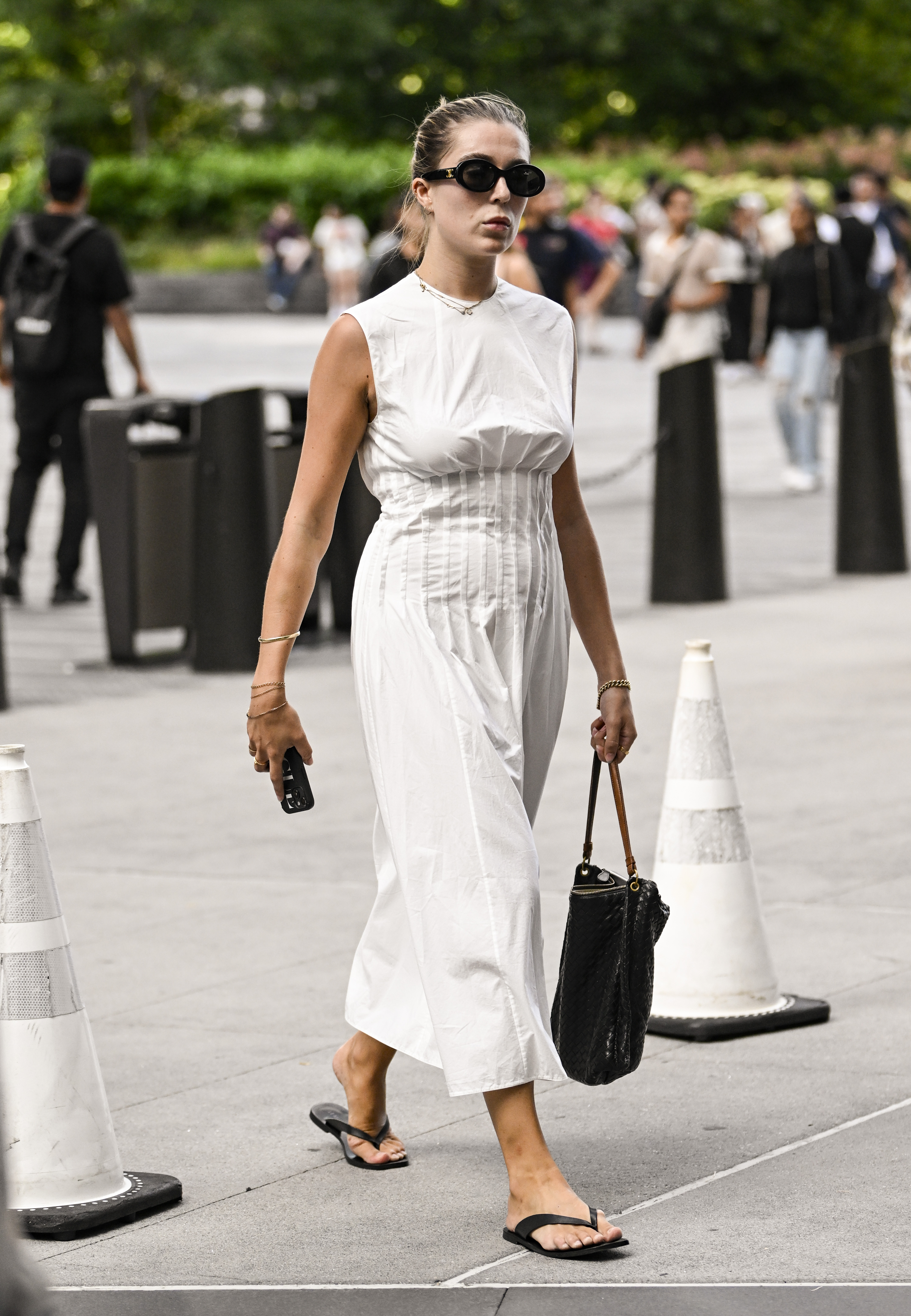 Woman wearing a white dress and flip flops