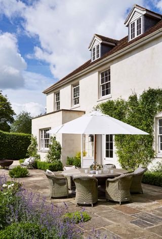 table chairs and parasol on patio paving ideas in classic garden