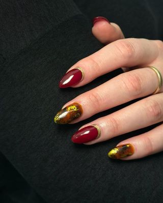 Red and gold manicure by Queenie Nguyen