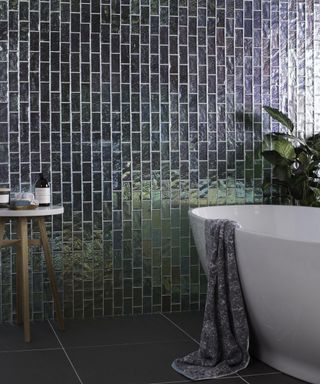 Blue iridescent tiles in a bathroom with freestanding bath by Original Style