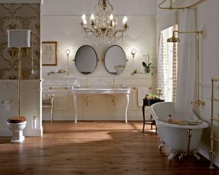 White and gold bathroom suite with toilet, vanity, bath and towel rail by Retrobad