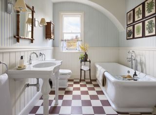 bathroom with chunky sanitaryware, checkerboard flooring and striped wallpaper