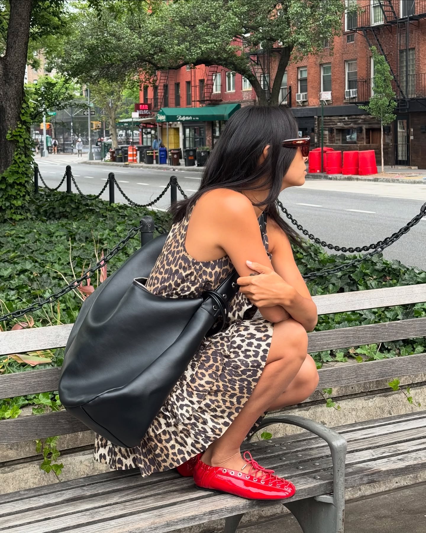 Michelle Li wearing a leopard print dress, red ballet flats, and a black leather bag in NYC